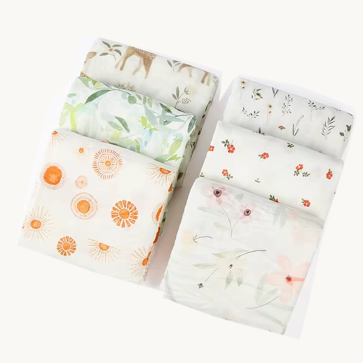 Couvertures MINUS en mousseline bambou et coton, pliées pour montrer six motifs inspirés de la nature.