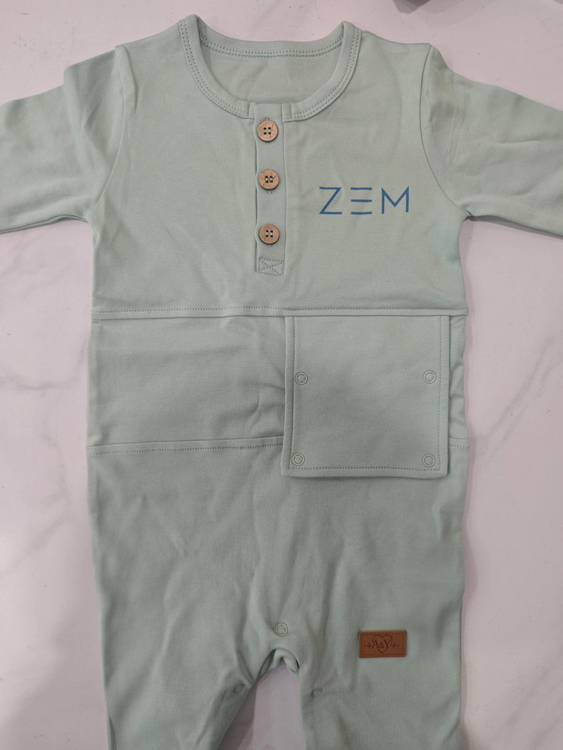 Prototype de la combinaison ZEM sauge : rabat abdominal fermé, boutons au col, logo ZEM et étiquette A&Y / Sage ZEM romper prototype: abdominal flap closed, buttons at the collar, ZEM logo and A&Y label